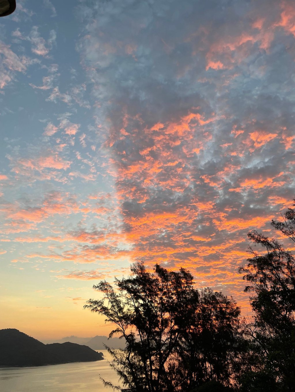 a sunset sky with a cross - country road sign