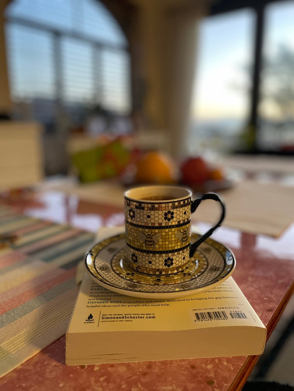 a cup of coffee and a book on a table