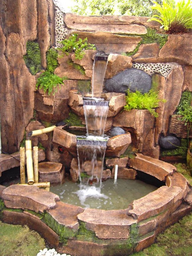 a waterfall fountain with a waterfall in the middle