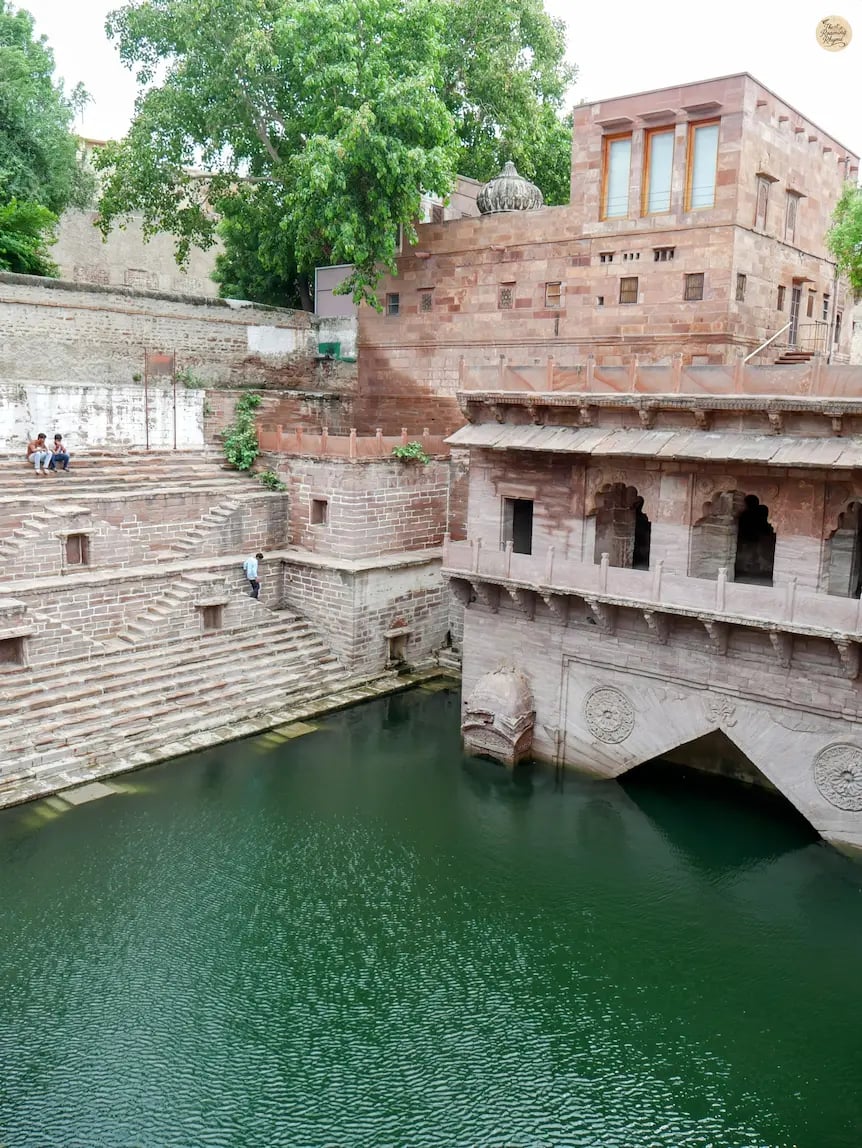 Toorji ka Jhalra stepwell in Jodhpur with intricate stone steps and glimmering water.