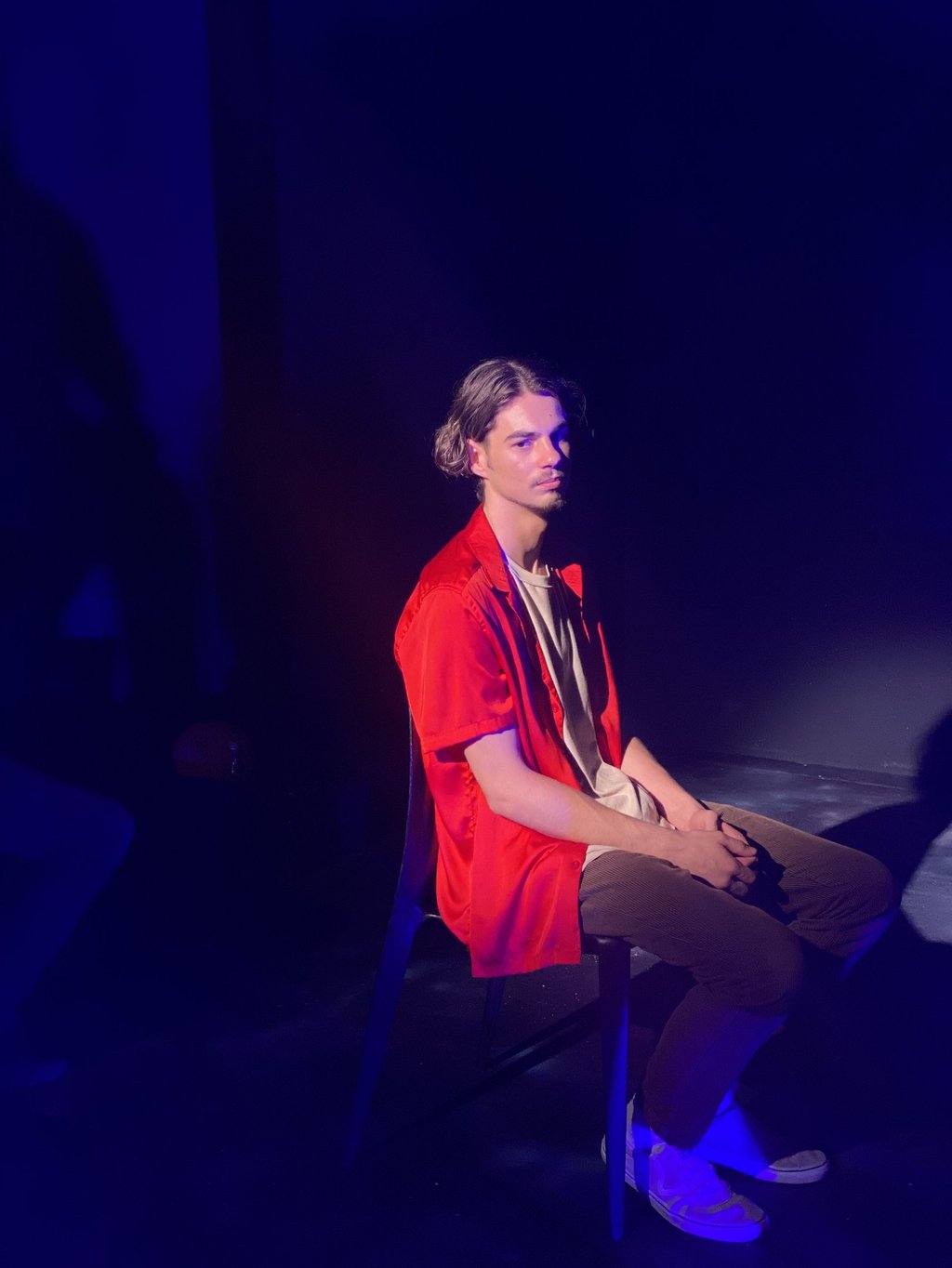 a man sitting in a chair with a guitar