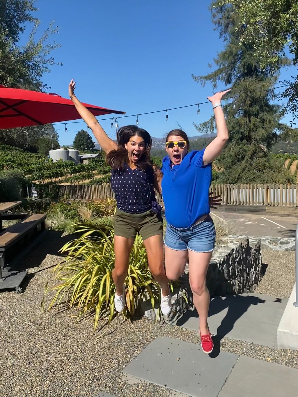 Image of two women jumping for joy.