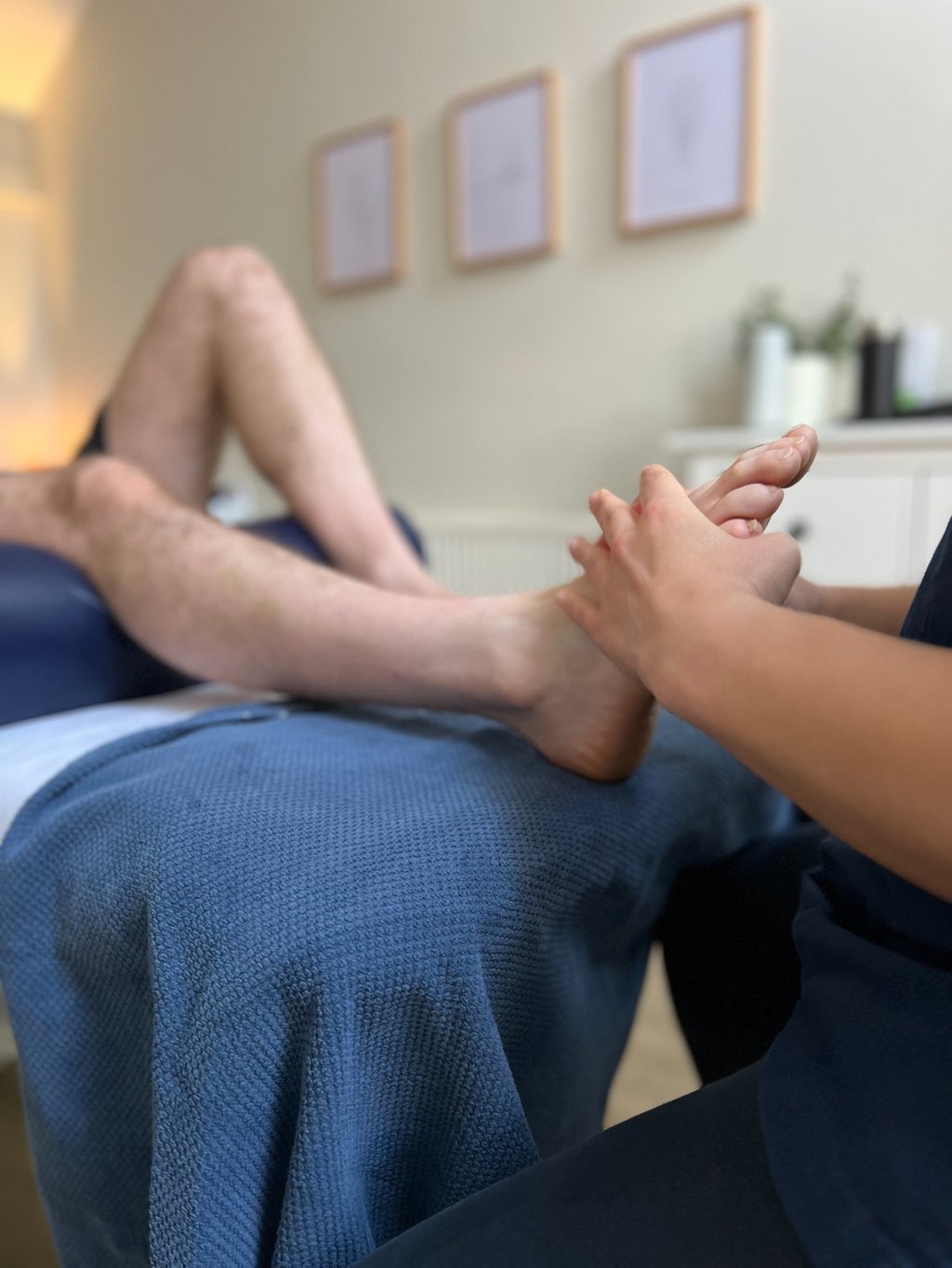 foot being assessed by practitioner as part of reflexology treatment