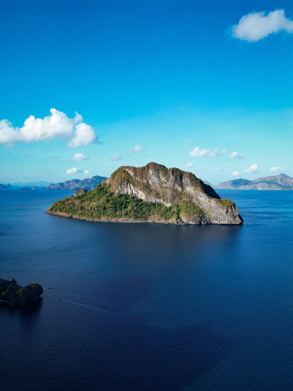 a small island with a small island in the middle of the ocean