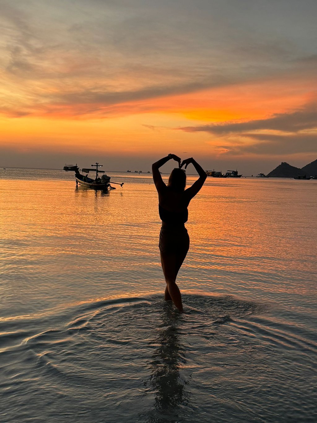 woman in the beach silhouette beautiful sunset  in the background