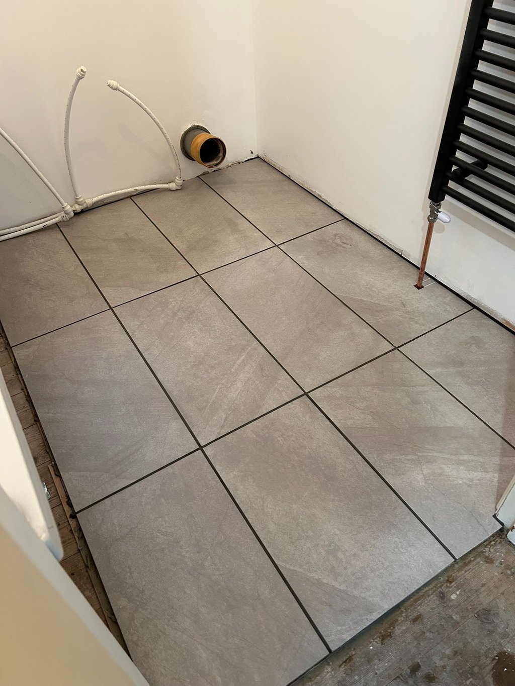 Toiler gone! Floor down, radiator in.