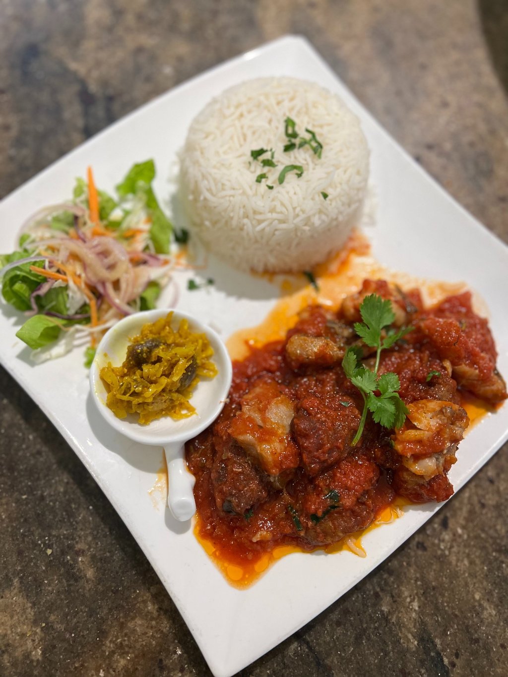 a plate of food with fish daube, rice and vegetables