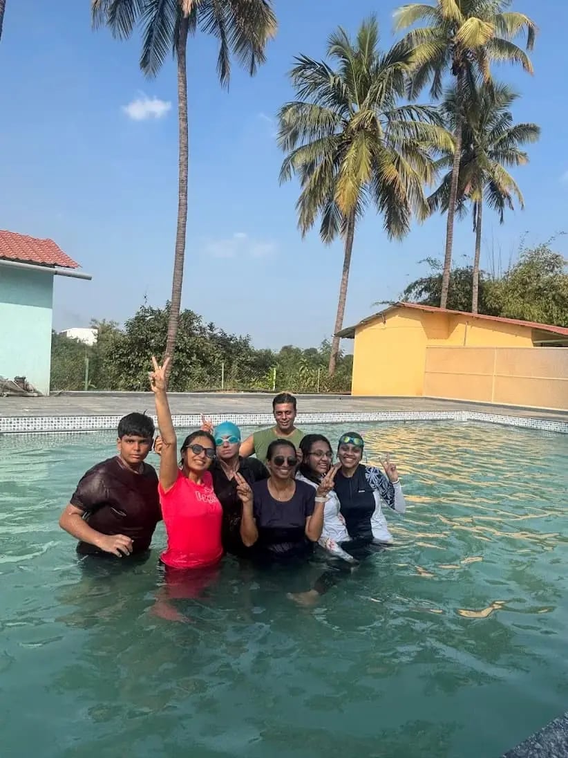 Family with kids enjoying swimming pool on one day picnic at purna river retreat