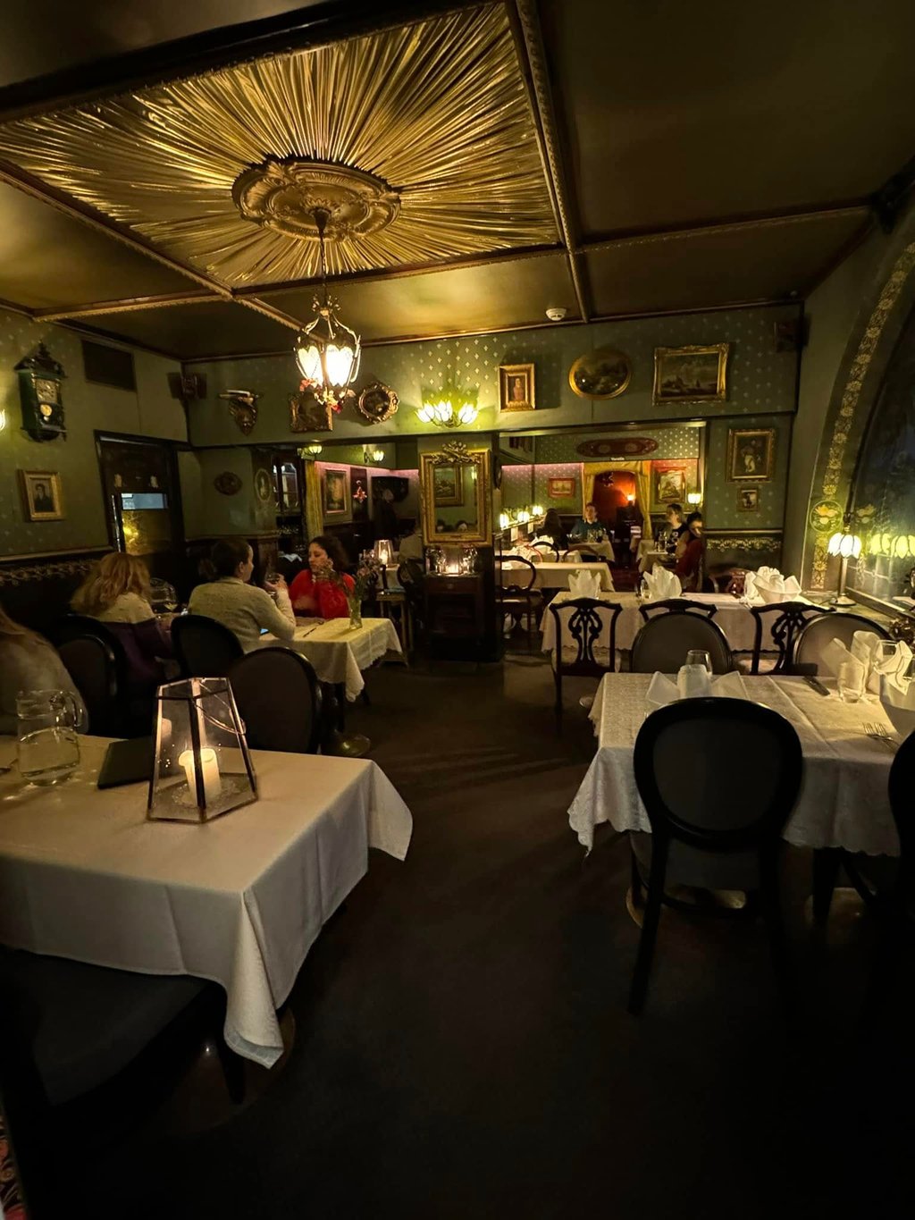 a restaurant with candlelit tables and chairs