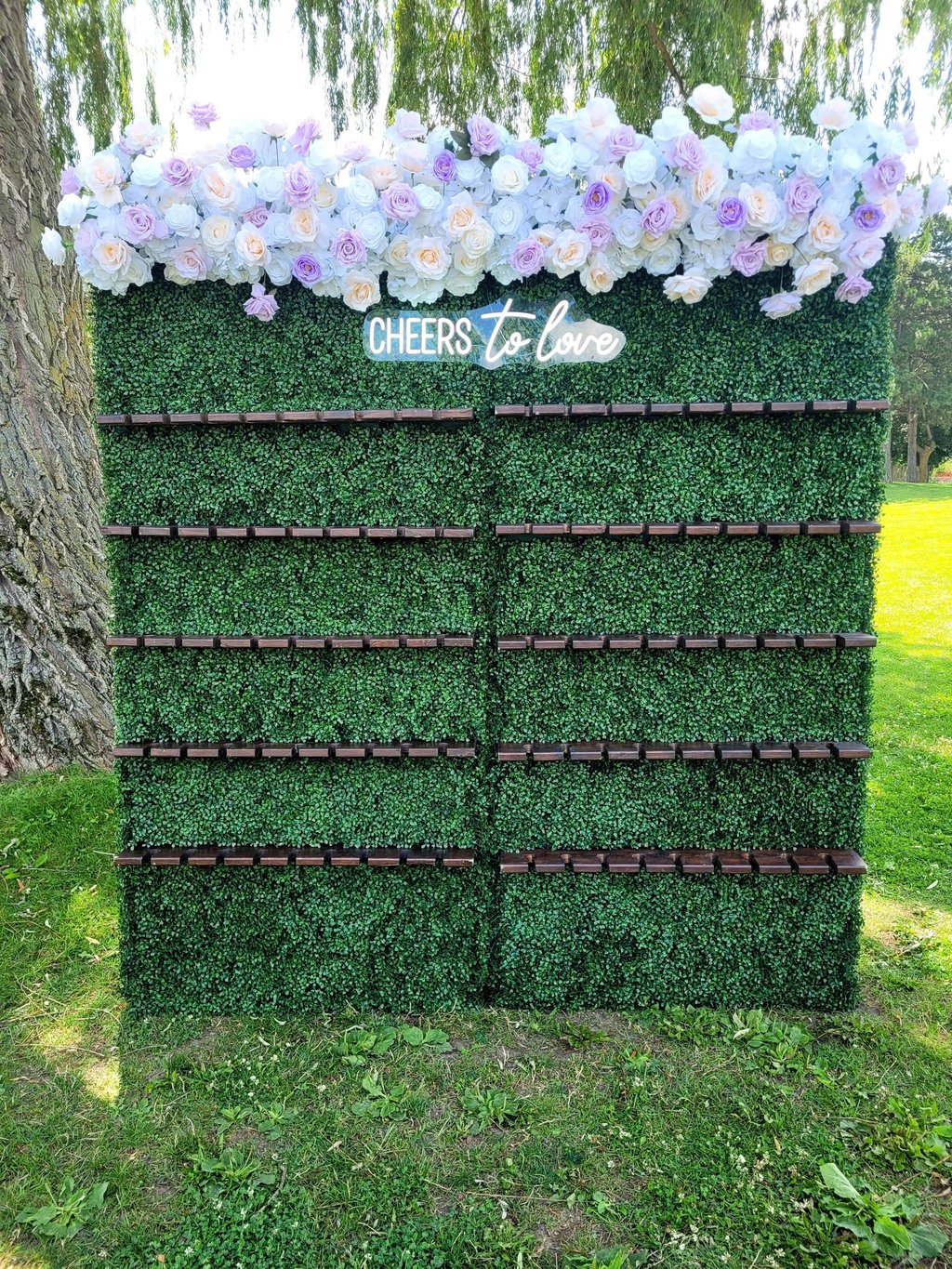 Champagne wall with lavender and white top flower arrangement.