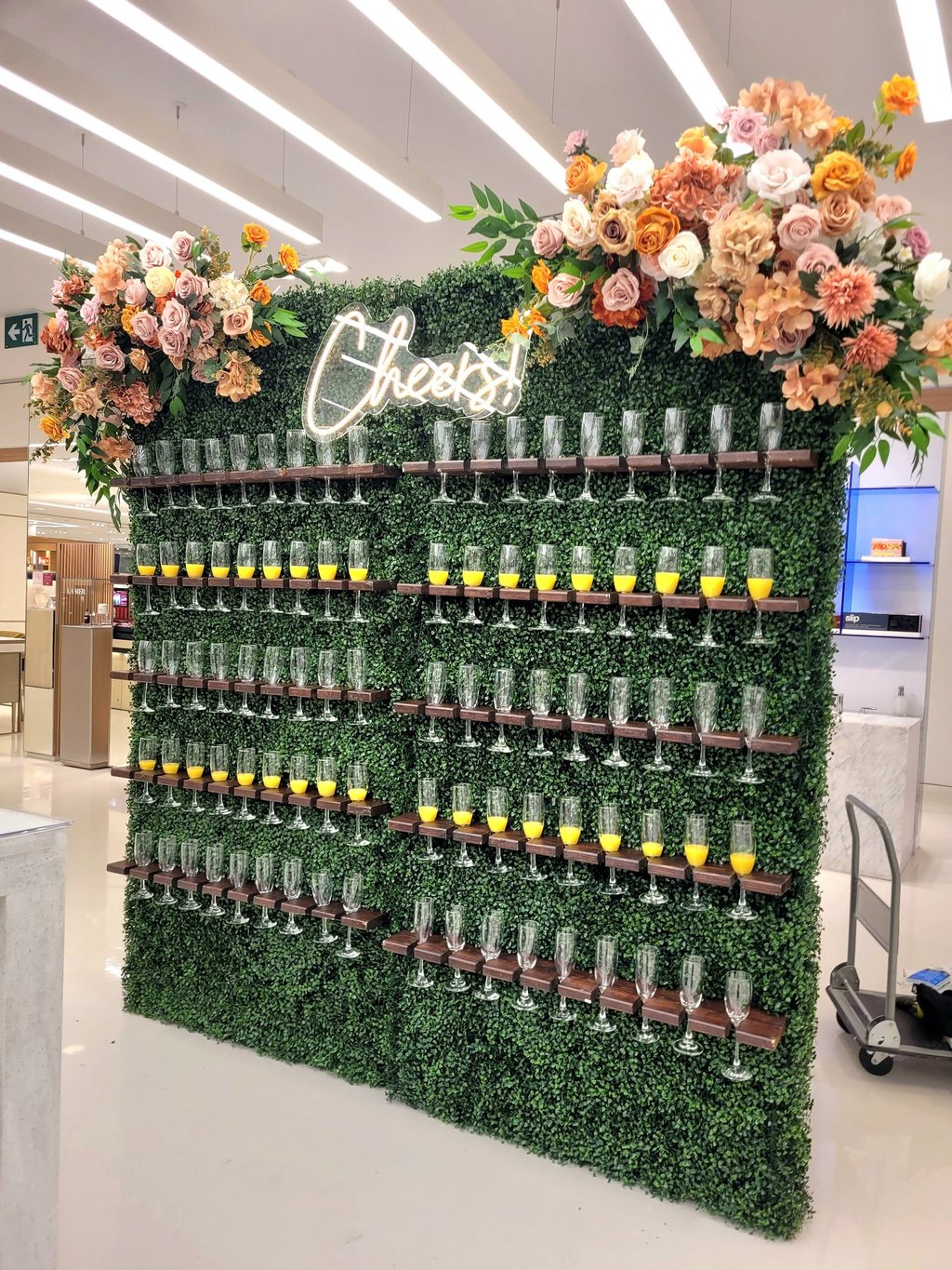 doubl champagne wall of flowers and wine glasses on display