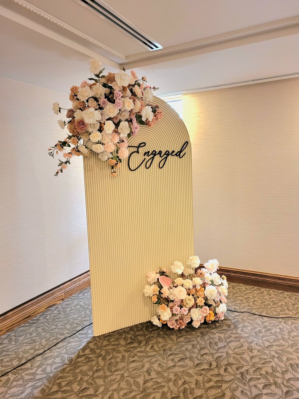 engagement party backdrop with a beige backdrop 