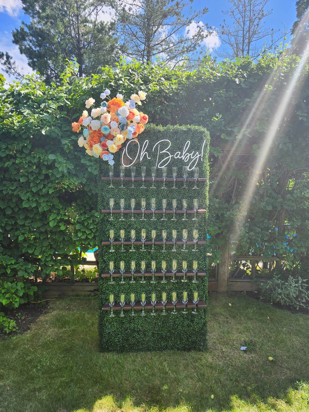 grass champagne wall with tropical floral arrangement