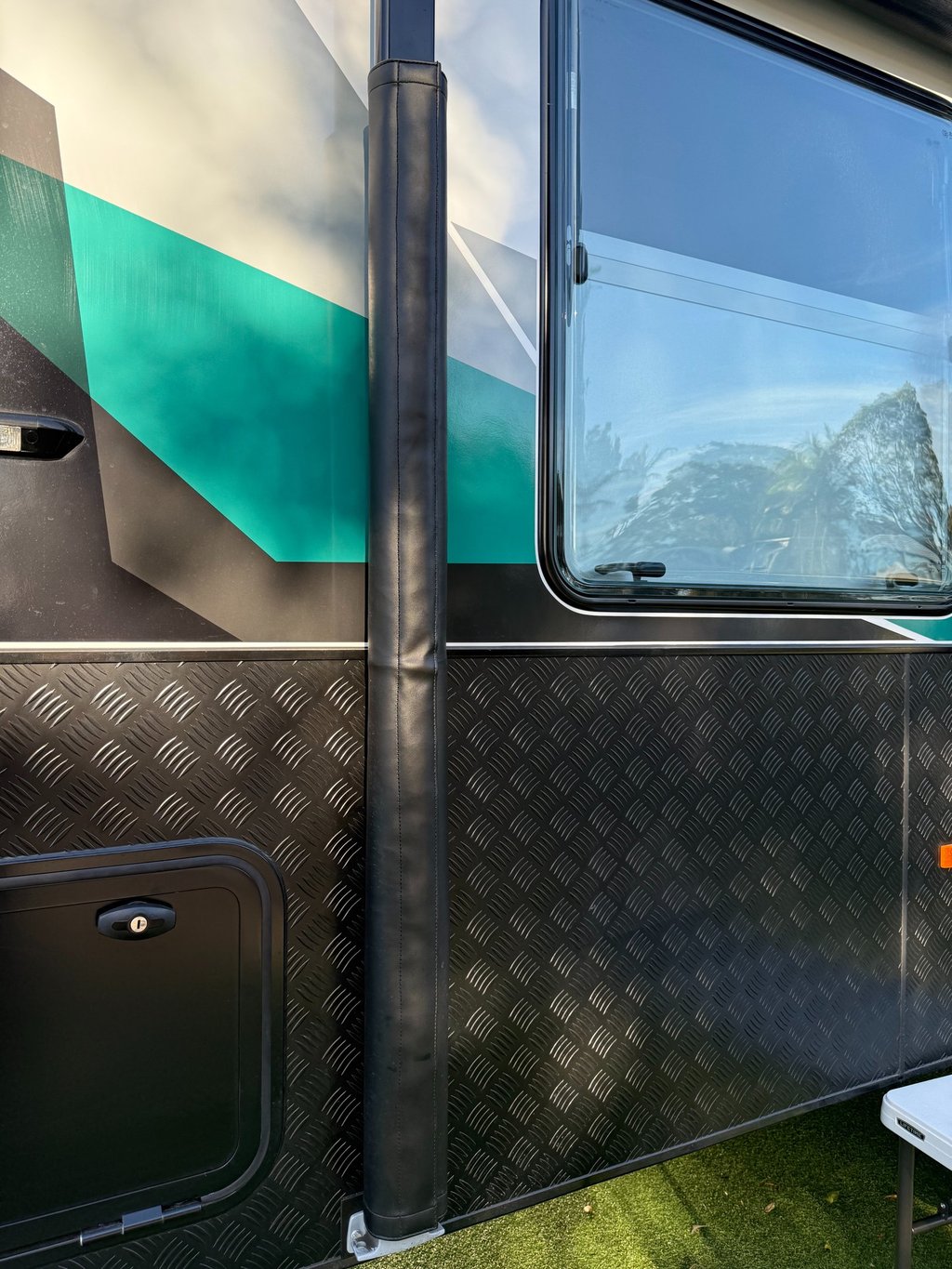 Durable awning arm covers protecting caravan hardware from road grime