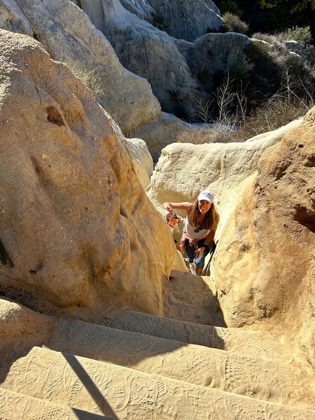 the author's mother climbing the staircase at the end of Annie's Canyon Trail. 