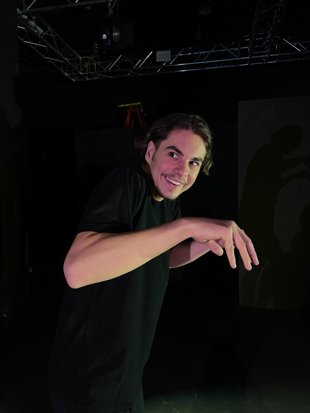 a man in a black shirt is holding a skateboard