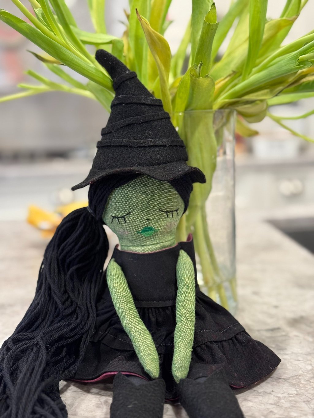 a stuffed toy of a green witch