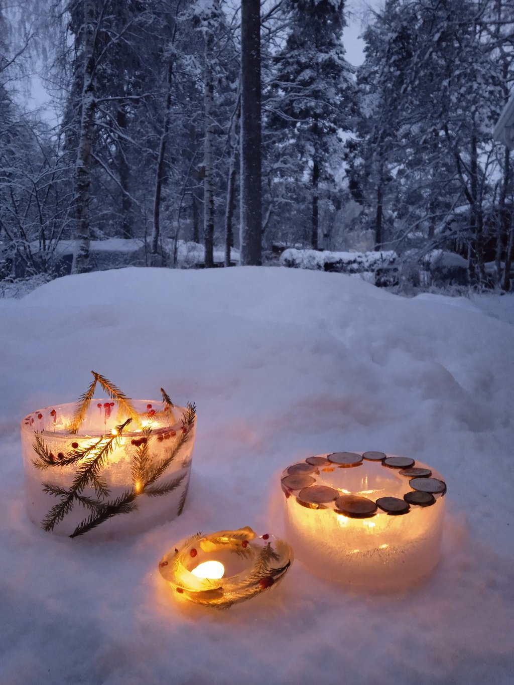 Ice lanterns glowing in the snow-covered forest at Nature Dream Days