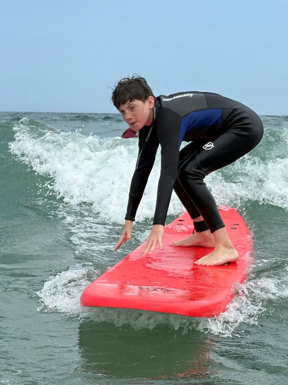 Teen boy surfing at north of Jenness Beach in Rye NH