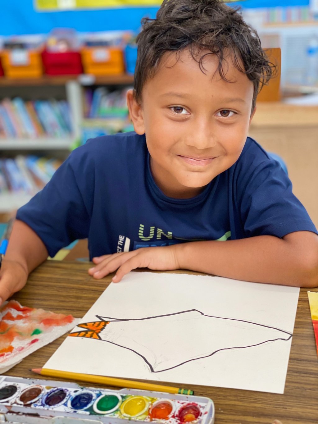child drawing on watercolor paper