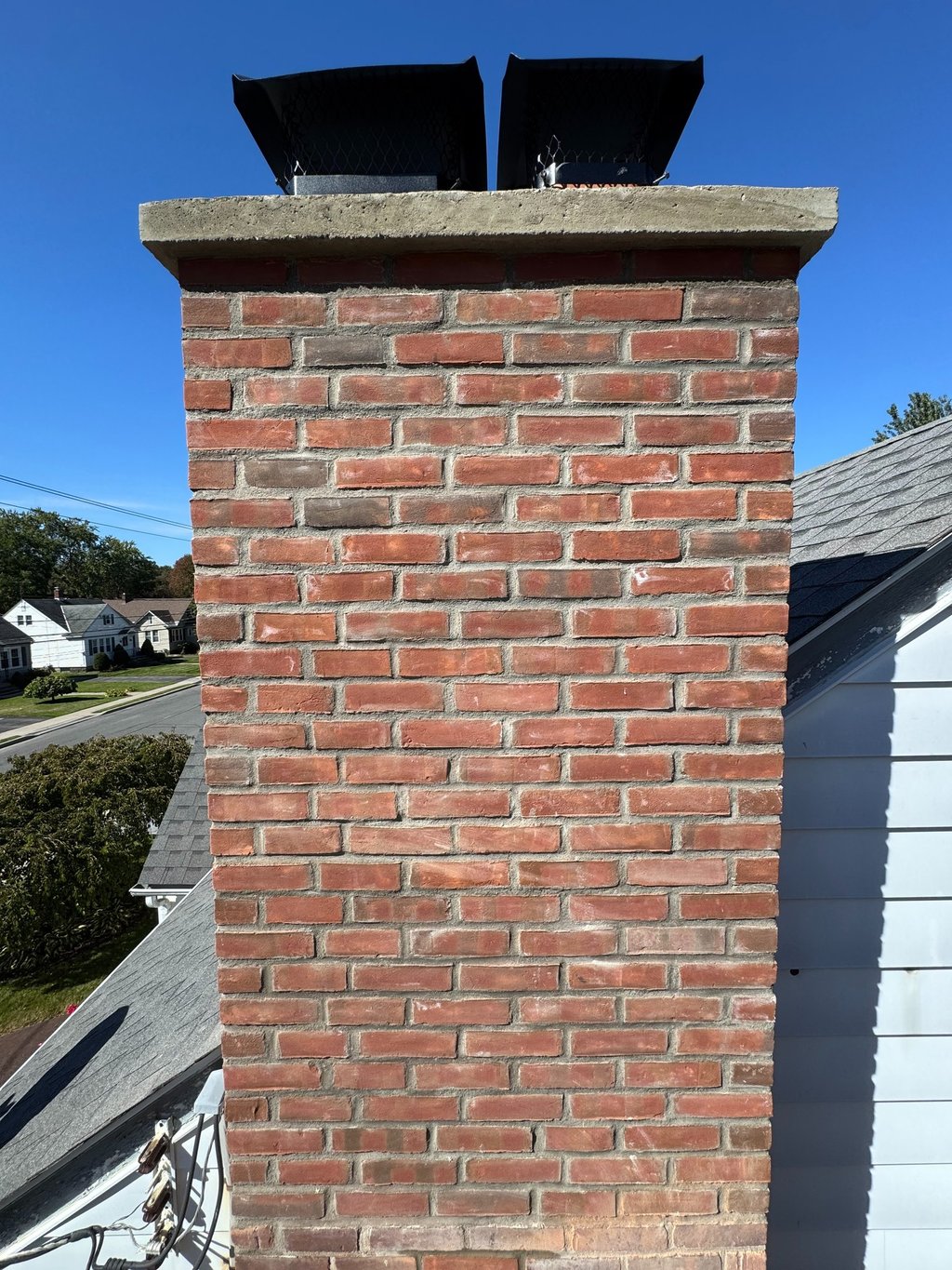 Chimney professional rebuild large chimney from roof line