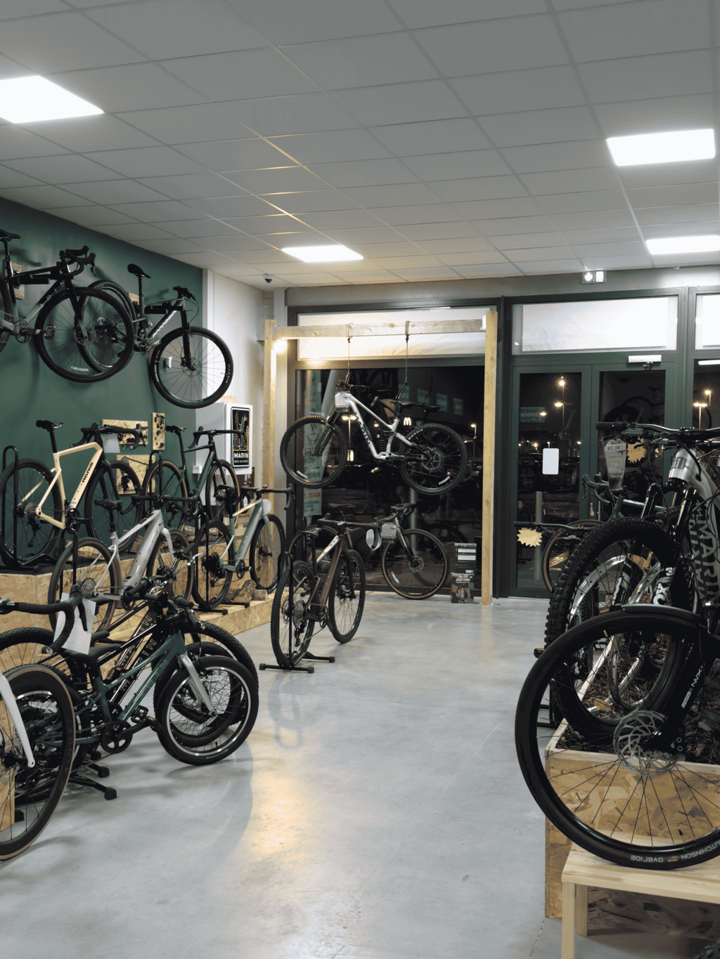 Showroom of a modern bicycle shop featuring rows of mountain bikes and road bikes on display.