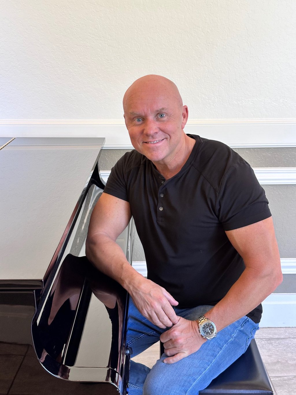 Composer Mark Bulmer sitting at the piano