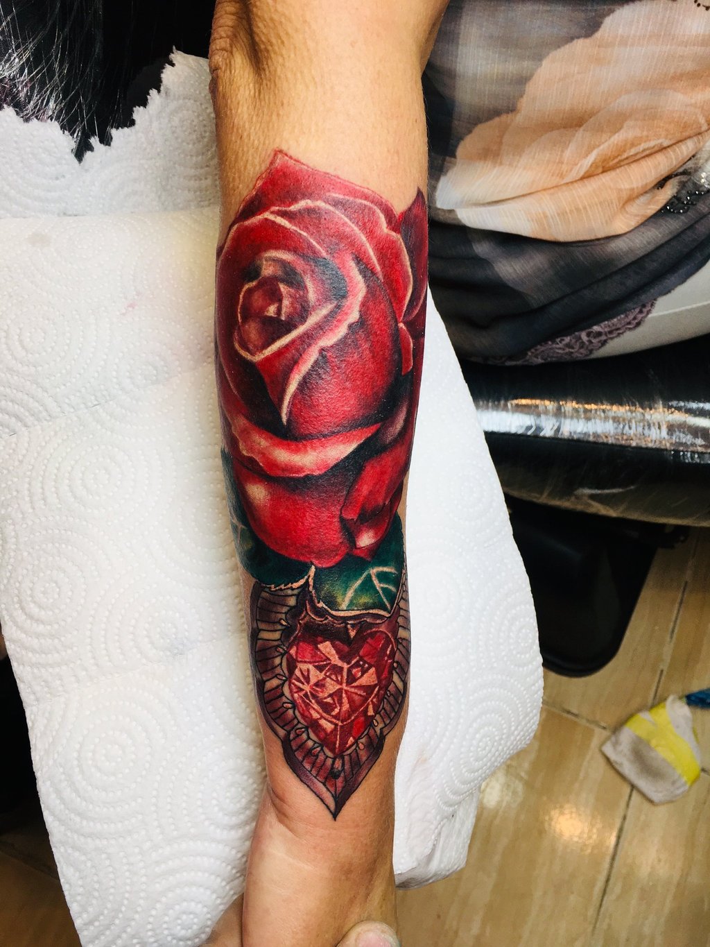 Rose tattoo in colouring on forearm — Hurghada Tattoo Studio