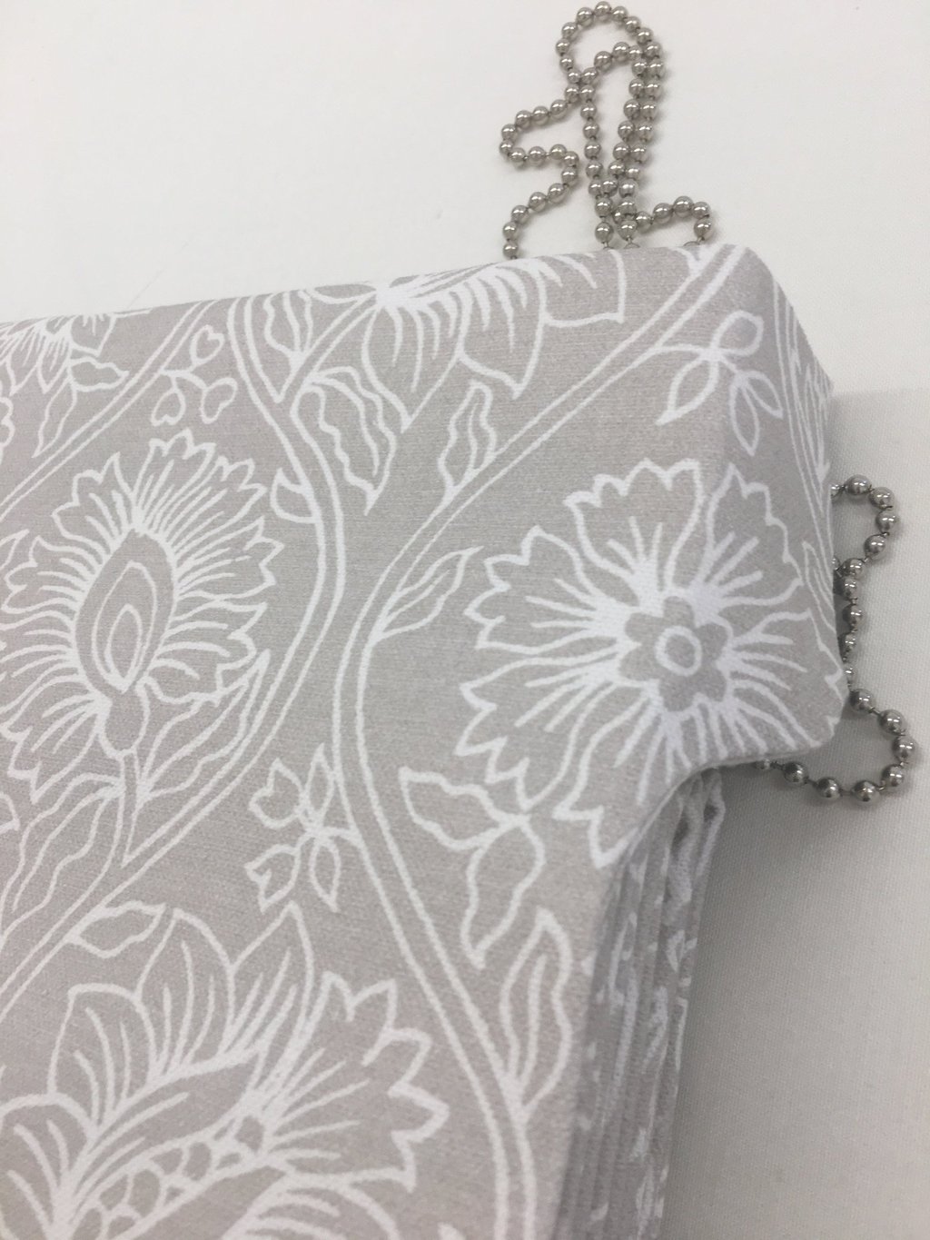 A roman blind with side tab to hide headrail