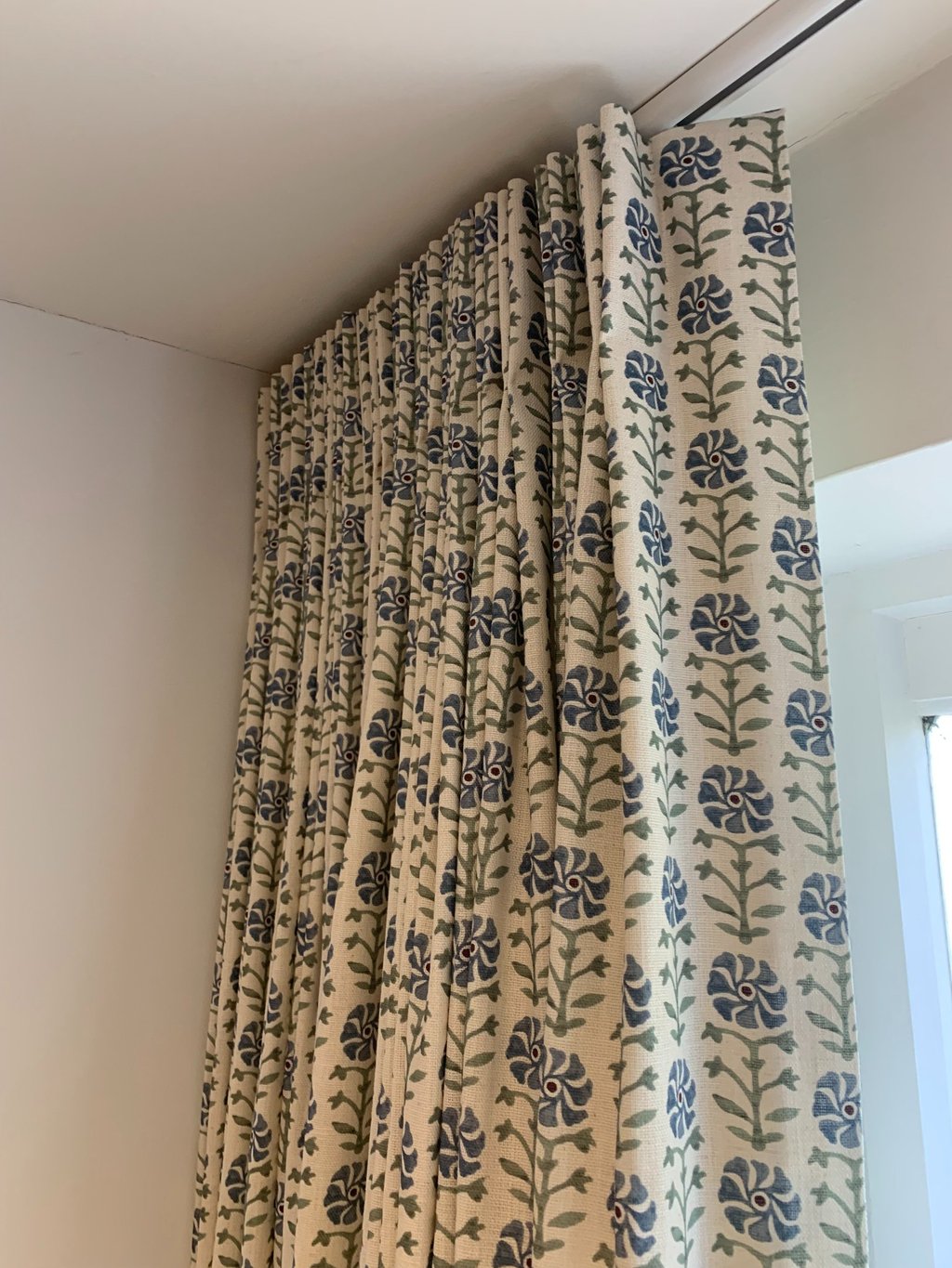 curtain with stitched single pleats hanging on a ceiling track