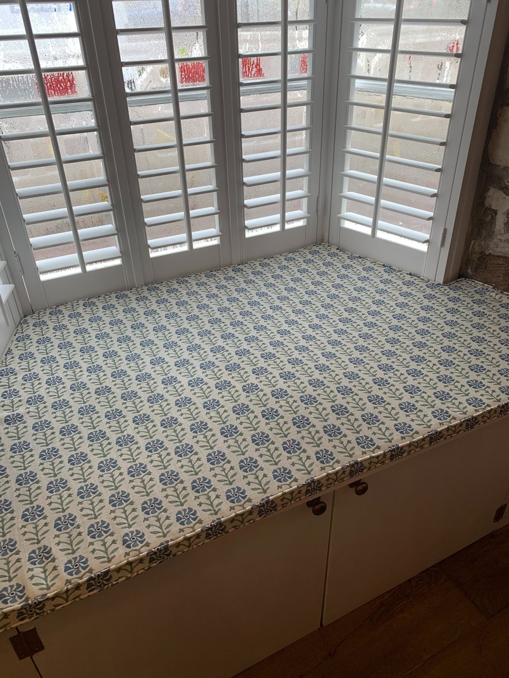 A bespoke window seat cushion shaped to fit an awkward space.