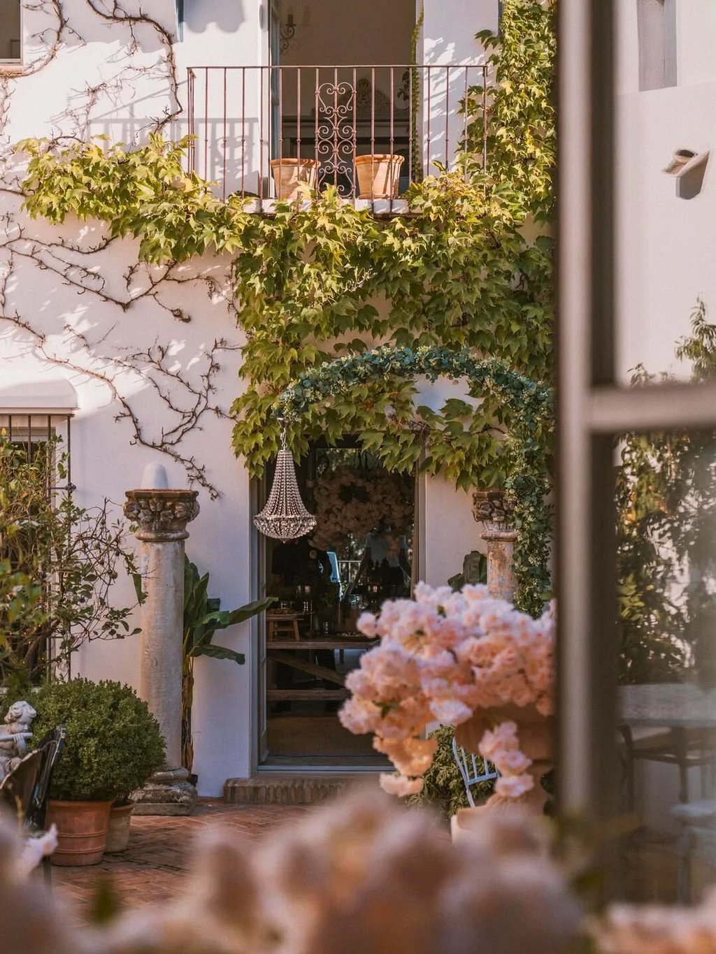 Rustic entrance with climbing greenery and floral details