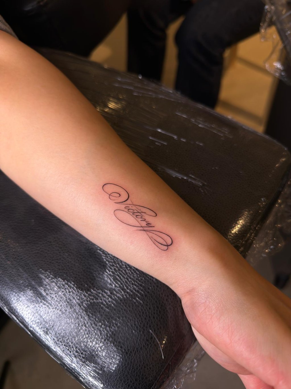 Fine line cursive lettering tattoo on arm – Sinkply Zürich