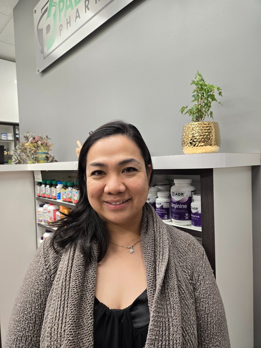 A woman smiling with medium length black hair