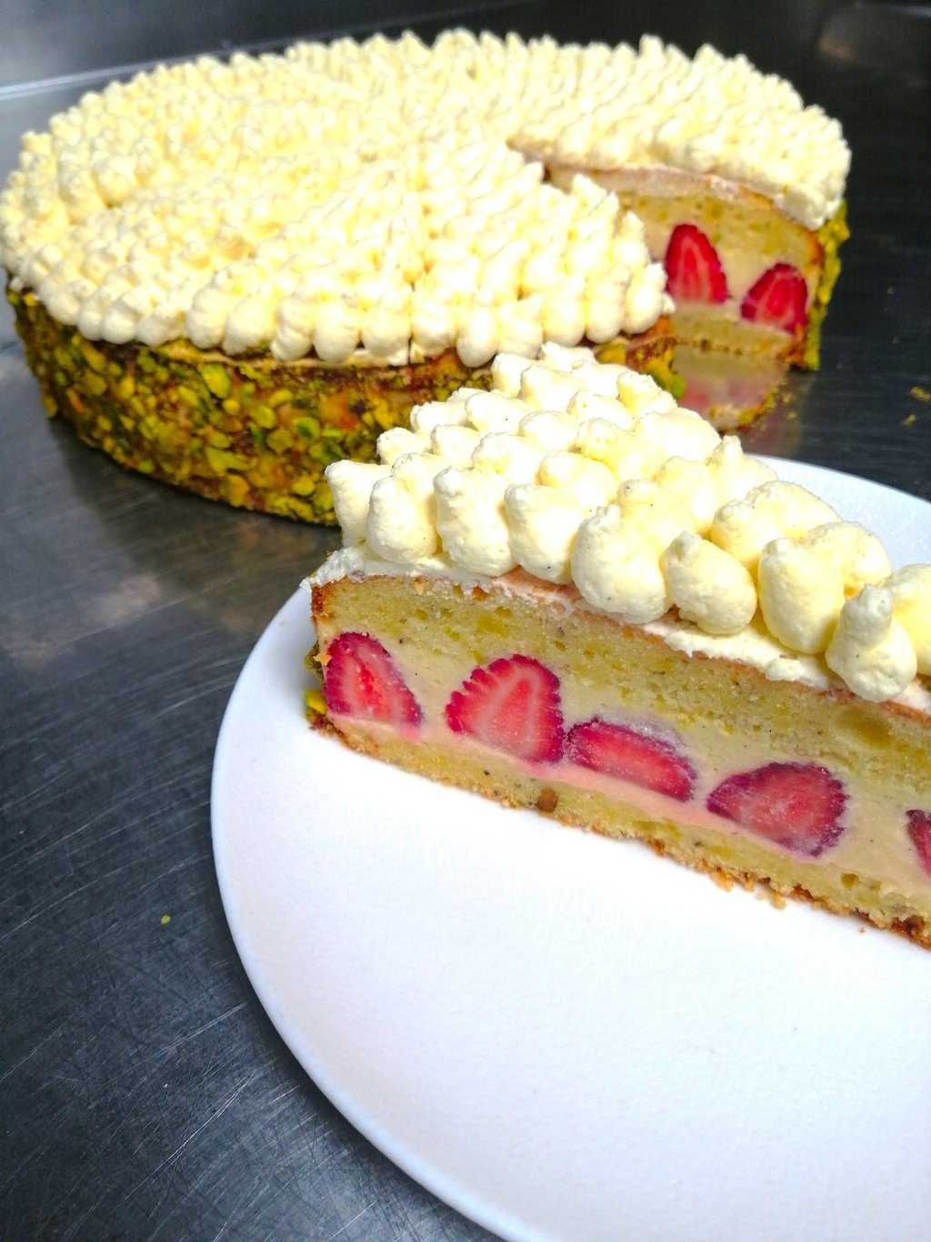 a strawberry cake with a slice of cake on top of it
