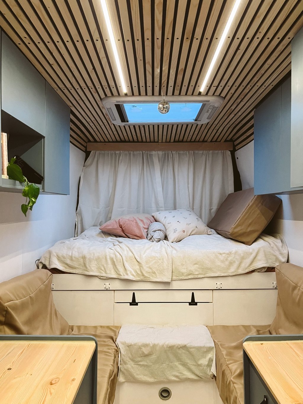 motorhome interior, a bed with some pillows on top