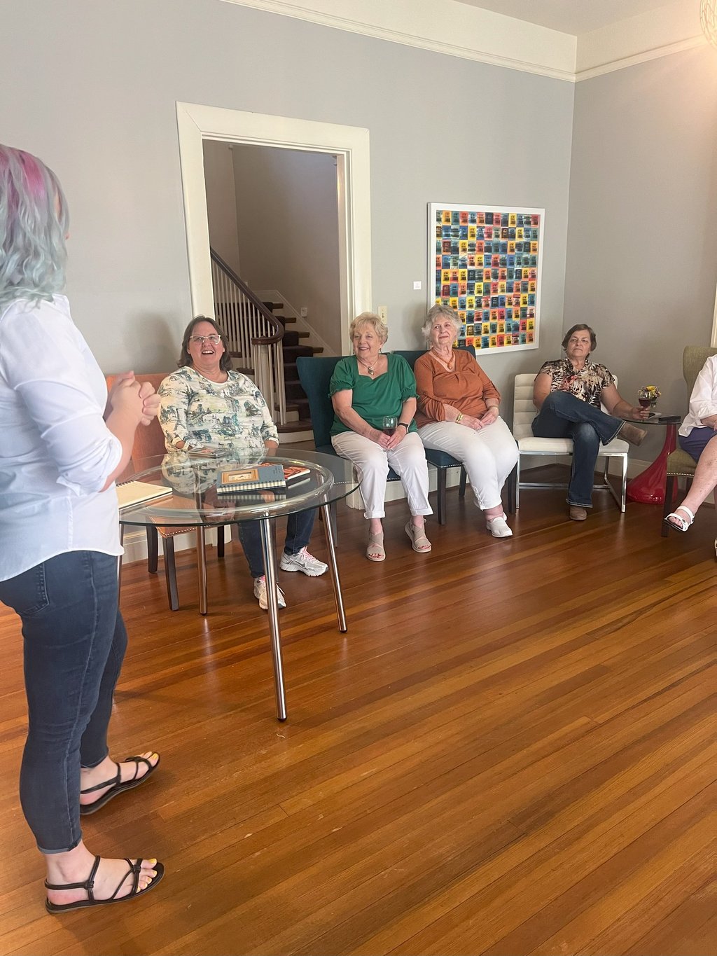 Tabitha with butterfly effect consulting talking to a group of clients at Main Street House