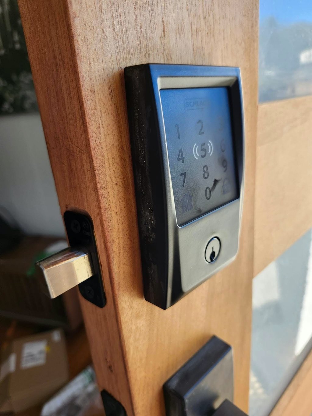 Keypad smart lock installed on a wooden exterior door