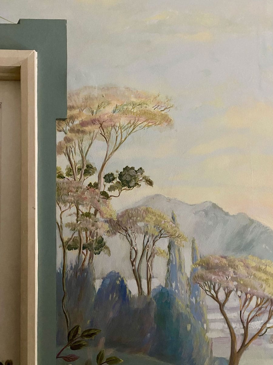 Detail of mural with painted architectural detail around a door frame, by House of Lyria