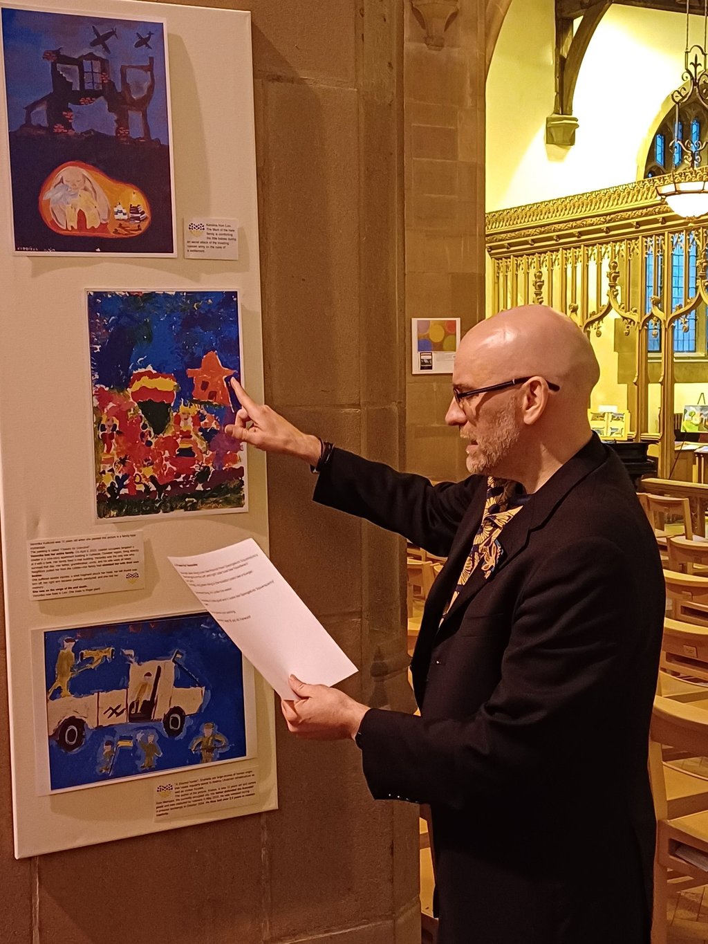 Poetry reading at Liverpool church showcasing paintings created by kids in the Ukrainian war