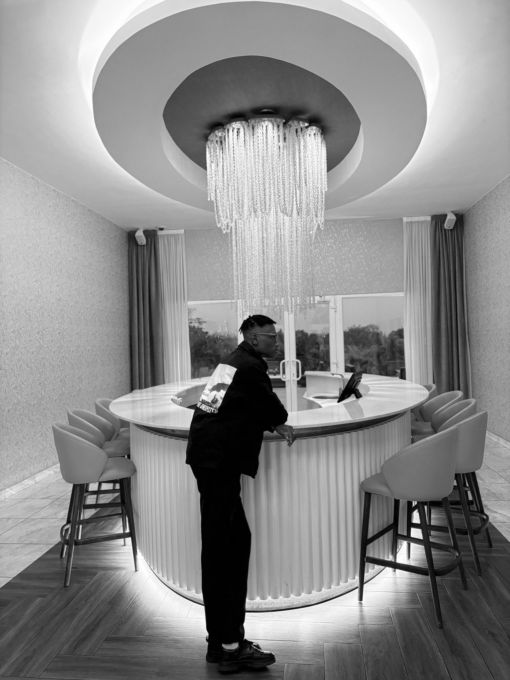 reed standing in front of a bar with a chandelier