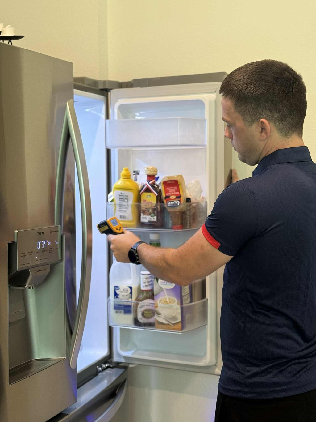 Jacksonville appliance repair technician checking refrigerator temperature