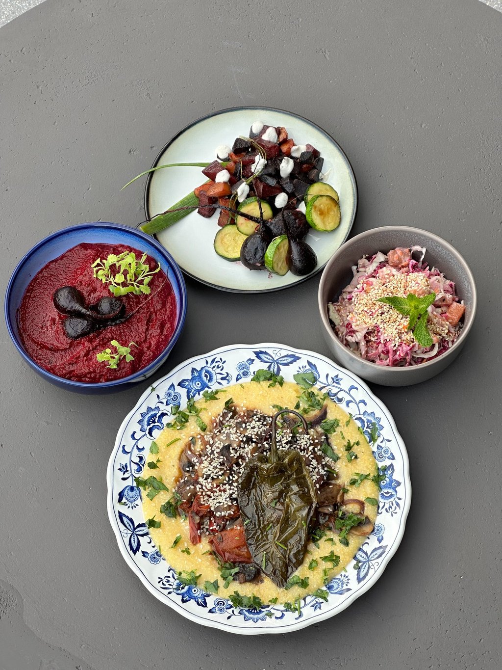 a table with bowls of food and vegetables