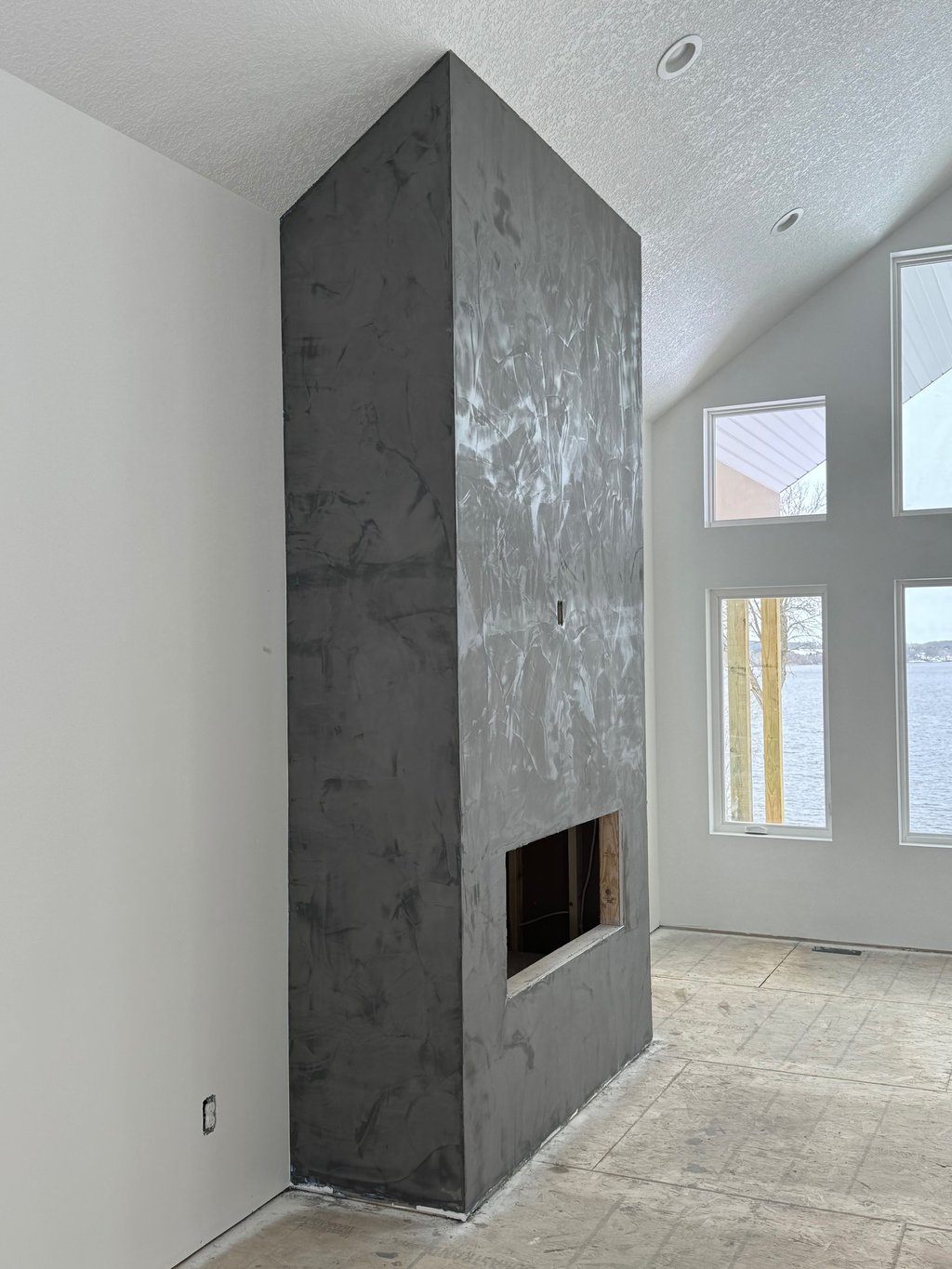 custom home with textured ceilings and custom fire place