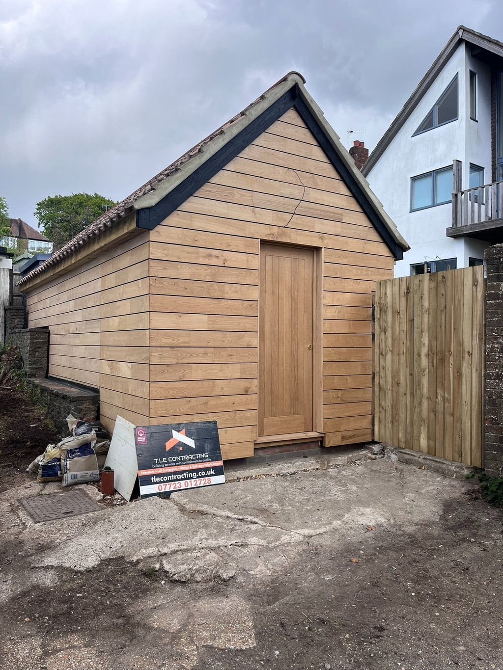 Brighton garage conversion with sweet chestnut timber cladding and insulated pitched roof
