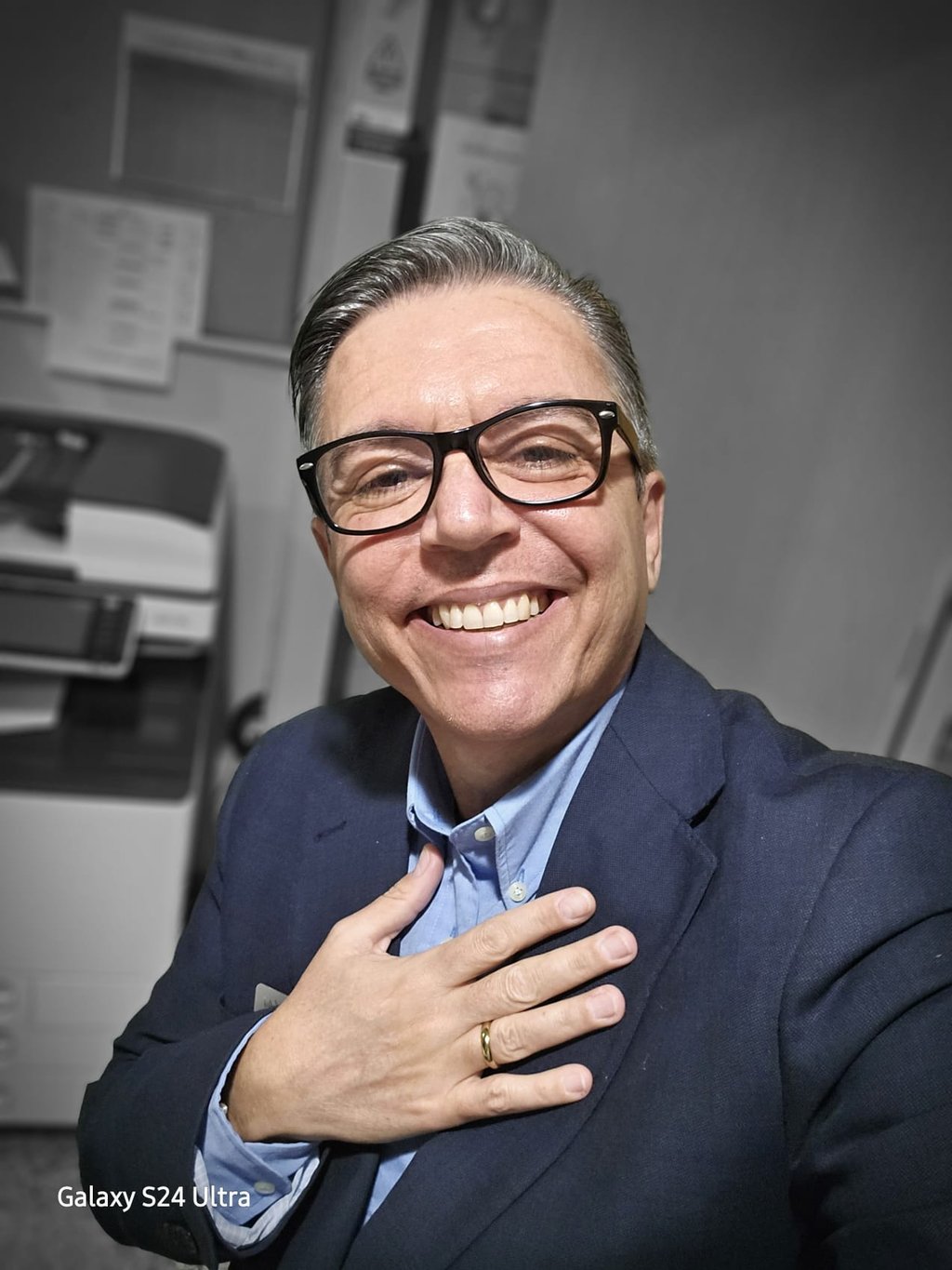 a man in a suit and tie smiling