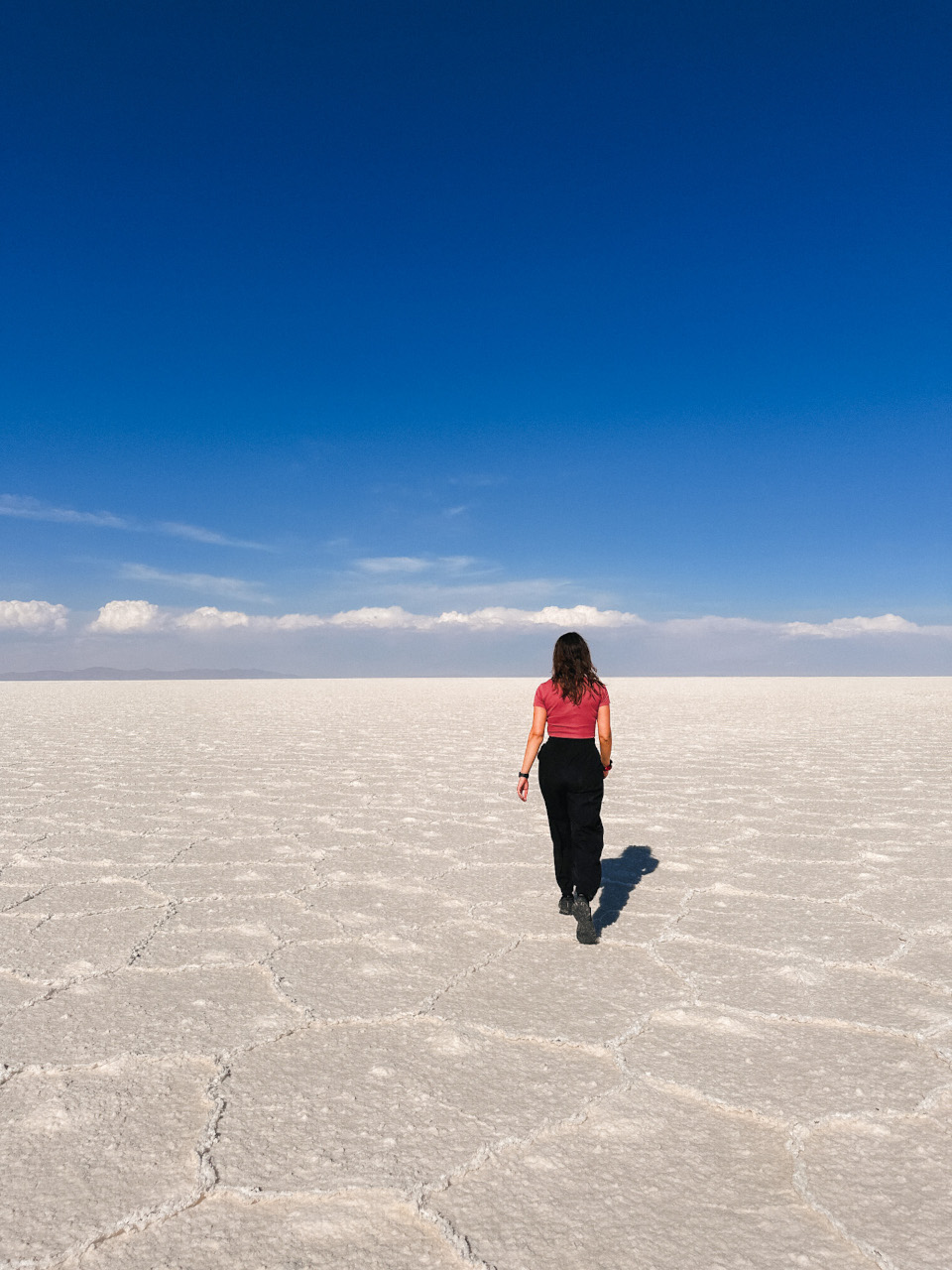 Girl in Salar de Uyuni, salt desert in Bolivia, South America