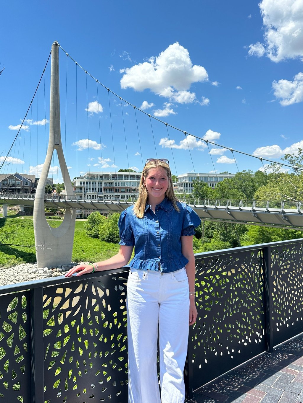 Young woman standing in front of The Link bridge