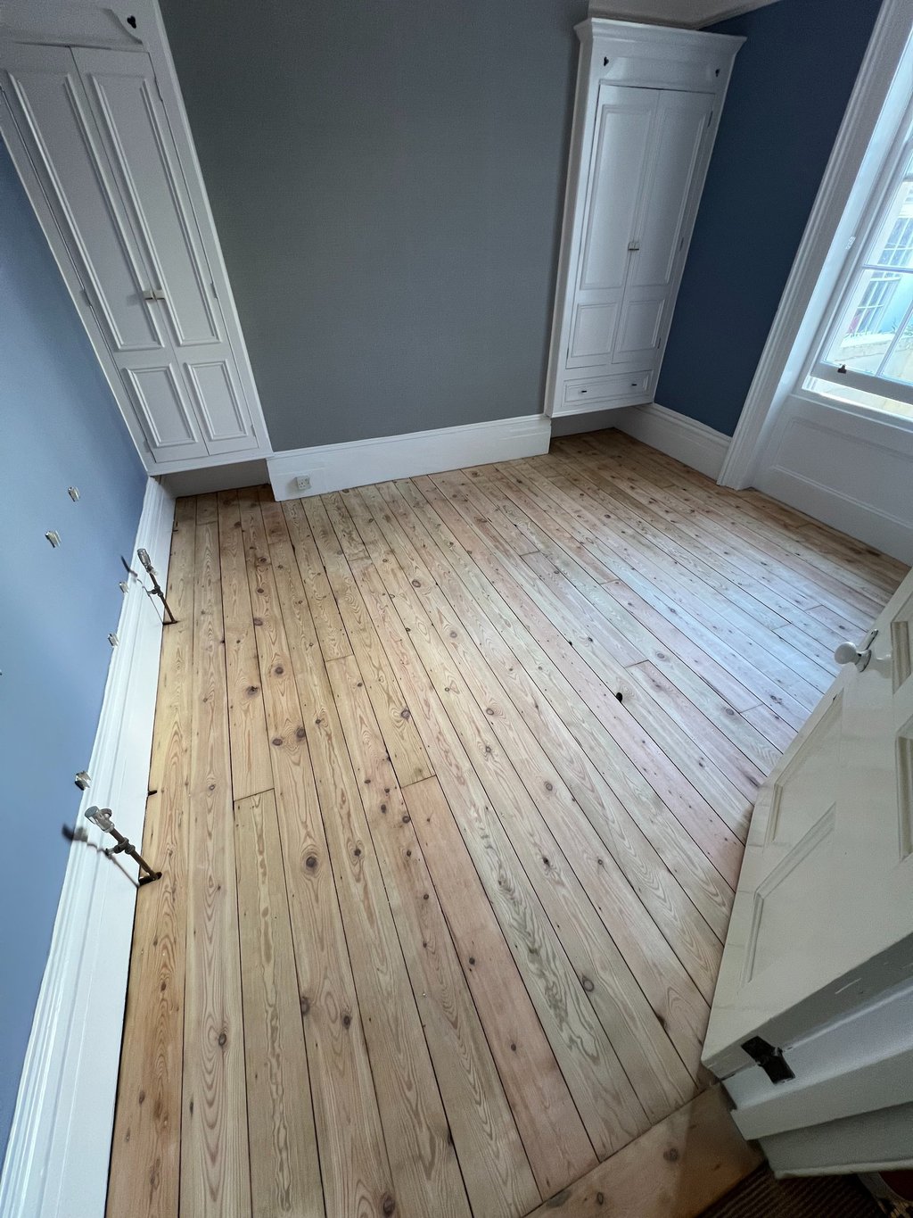 Stripped pine floorboards in Worthing Sussex, wooden floor restoration before finish