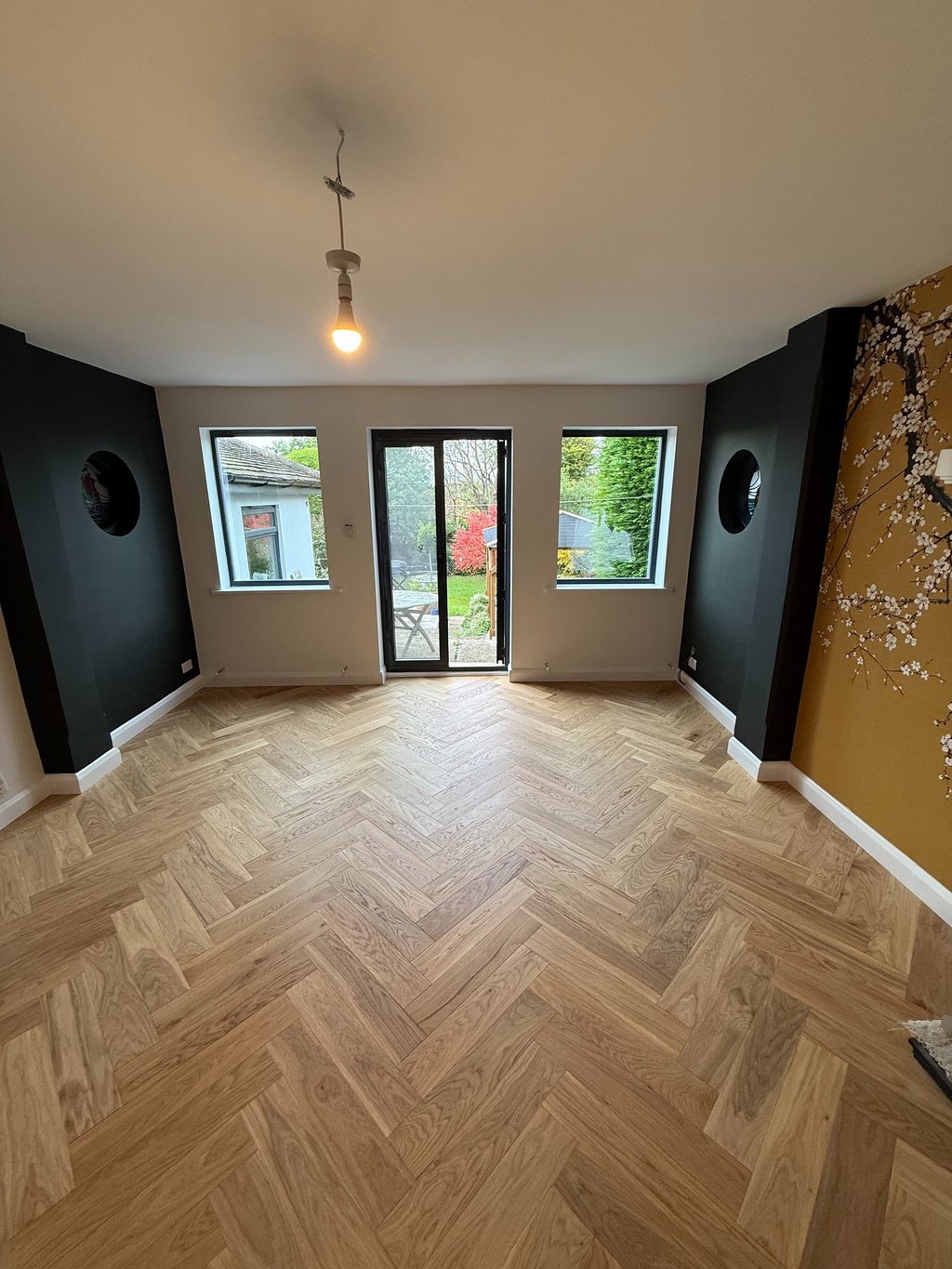 Wood flooring installation in a Brighton living room with fireplace